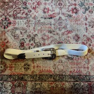 Elegant White Belt with Intricate Silver Buckle